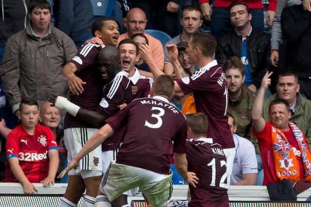 Osman Sow celebrates with Hearts players at Ibrox.