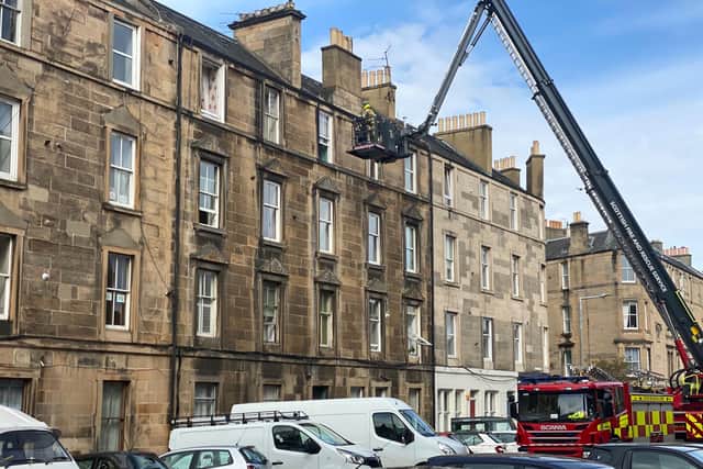Fire engine cherry picker with fire officer seen helping evacuate residents from flat building on Iona Street in Leith (Photo: Alexis Woods).