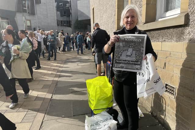 A special souvenir edition of The Scotsman was selling like hot cakes as crowds flocked to Holyrood to witness the historic day and pay their respects to the Queen. Picture: Ilona Amos