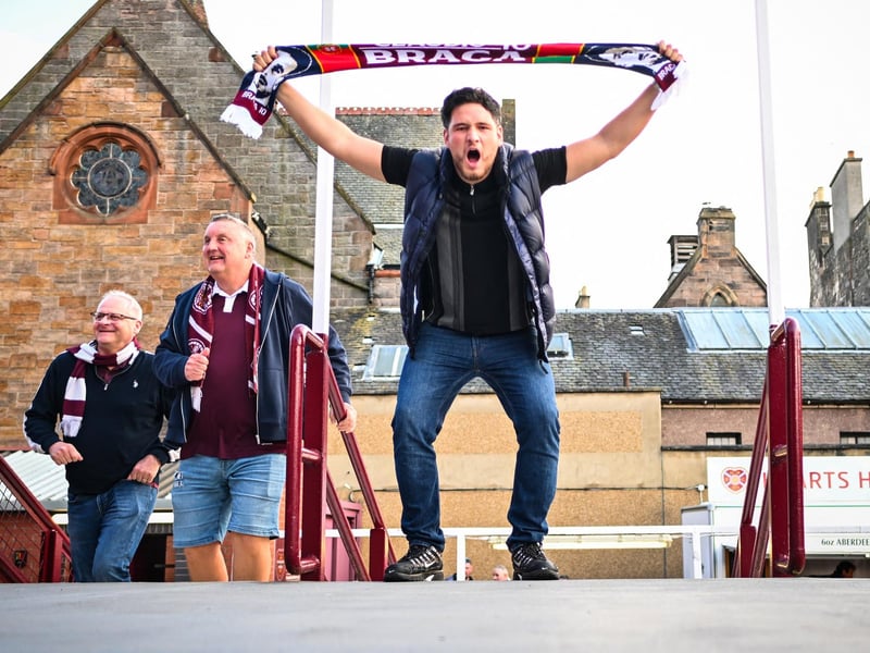 Hearts supporters react as they arrive before the start of the match (Photo by ANDY BUCHANAN / AFP via Getty Images)