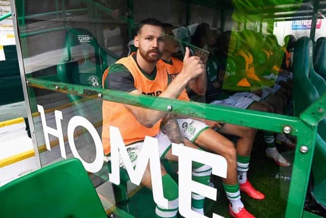 Martin Boyle taking a seat among the substitutes prior to his incredible reintroduction to the Hibs support at Easter Road. Picture: SNS