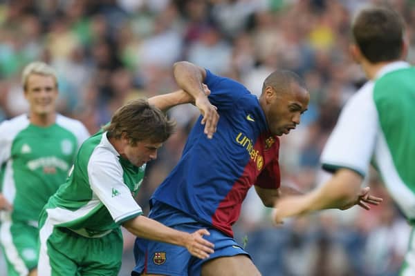 Thierry Henry of Barcelona holds off Hibs' Lewis Stevenson during a pre-season friendly in July 2008. Picture: Gary M. Prior/Getty Images