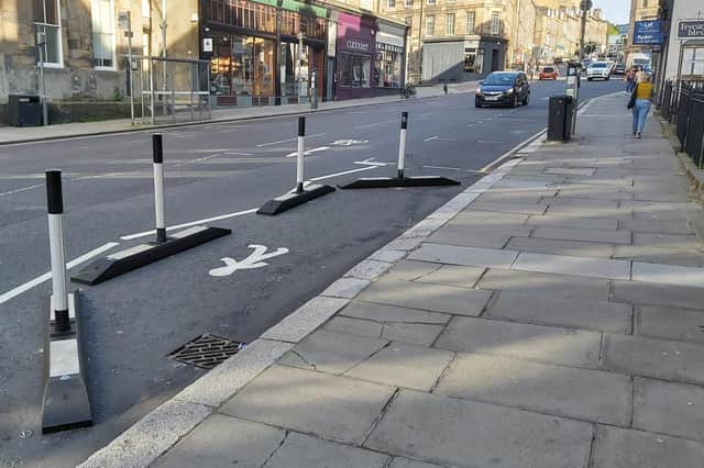 The Spaces for People bollards may be designed to be visible, but the bases can blend into the road surface (Picture: Steve Cardownie)
