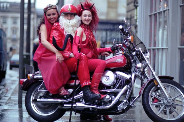 Edinburgh hairdresser Charlie Miller (as Santa Claus and riding a Harley Davidson motorbike) and his staff (Nicky Anderson and Andrea McSherry) in fancy dress a week before Christmas 1991.