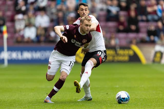 Nathaniel Atkinson skips past Bojan Miovski during Hearts' 2-1 win against Aberdeen.