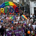 Pride marchers march up the Royal Mile in Edinburgh.