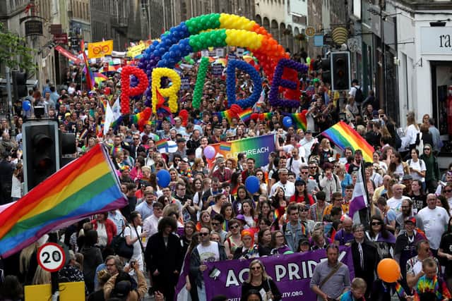 Pride marchers march up the Royal Mile in Edinburgh.
