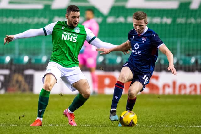 Hibs' Drey Wright and Ros County's Stephen Kelly battle for possession
