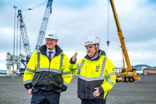 Alex Fyfe, managing director of OM Heavy Lift, and David Webster, director of energy at Forth Ports on site in the Port of Dundee with OMHL’s heavy lift cranes in the background. Picture: Peter Devlin