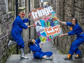 Cris Peploe, Claudia Cawthorne and Martha Haskins pose with a large-scale version of the Edinburgh Festival Fringe 2023 programme cover in the Old Town. Picture: Jane Barlow/PA Wire