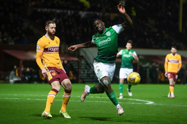 Hibernian's Rocky Bushiri goes down under pressure from Motherwell's Kevin van Veen. The pair enjoyed a physical tussle all night
