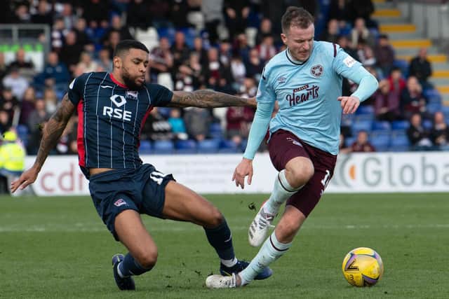 Andy Halliday skips past Ross County's Dominic Samuel during the 1-1 draw between Hearts and the Staggies in Dingwall earlier this month. Picture: SNS