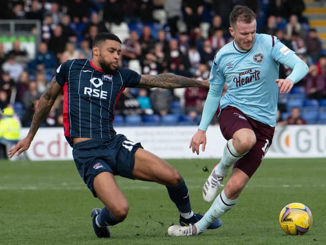 Andy Halliday skips past Ross County's Dominic Samuel during the 1-1 draw between Hearts and the Staggies in Dingwall earlier this month. Picture: SNS