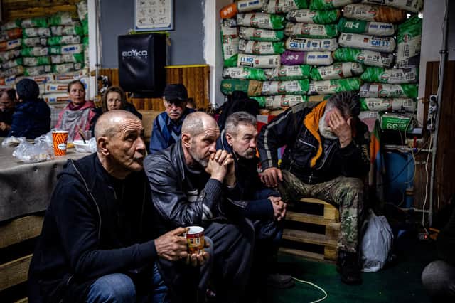Ukrainians take shelter in a humanitarian aid centre in the besieged town of Bakhmut on Monday (Picture: Dimitar Dilkoff/AFP via Getty Images)
