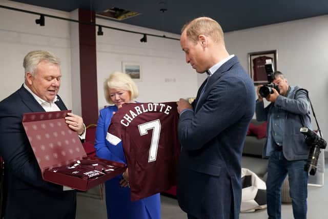 Prince William being presented with Heart of Midlothian football shirts for all three of his children. (Photo by JANE BARLOW/POOL/AFP via Getty Images)