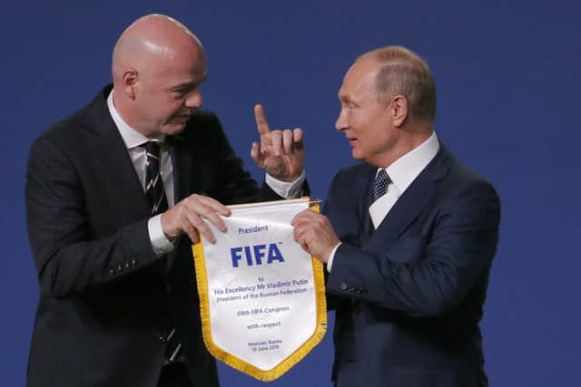 FIFA president Gianni Infantino, left, and Russian president Vladimir Putin pose for cameras at the FIFA congress on the eve of the opener of the 2018 World Cup