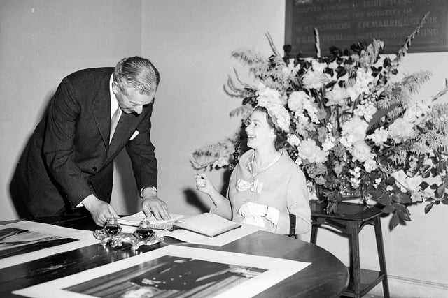 Queen Elizabeth II signing the visitors' book of Scotland's oldest boarding school, Loretto School, which is situated just outside Edinburgh, in Musselburgh, on July 1 1958.