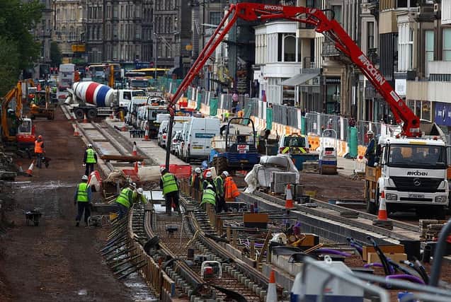 Workmen can be seen here continuing to work on the Edinburgh tram project on Princes Street, on 30 September 2009.