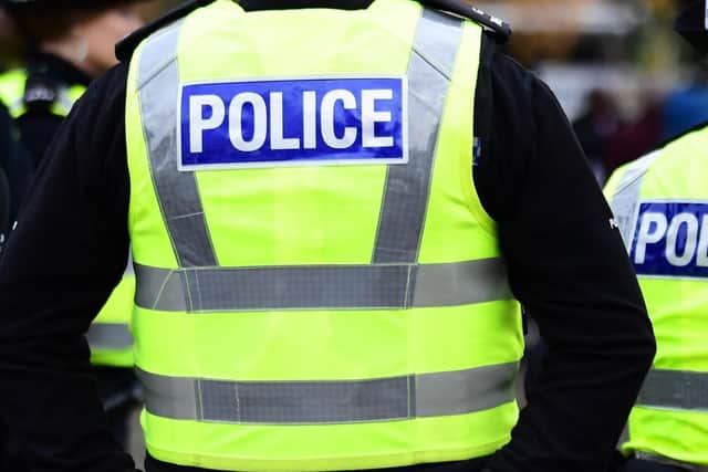 A female pedestrian has been take to hospital, and a teenager arrested, after crash involving a number of vehicles at a busy junction in Edinburgh.