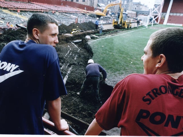 Hearts youngsters Scott Severin and Gary Naysmith watching the bulldozers move in at Tynecastle in 1997 to clear the Gorgie Road End for work to start on a new stand.