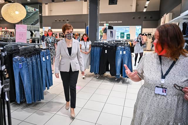 First Minister Nicola Sturgeon, wearing a Tartan face mask during a visit to New Look at Ford Kinaird Retail Park in Edinburgh.