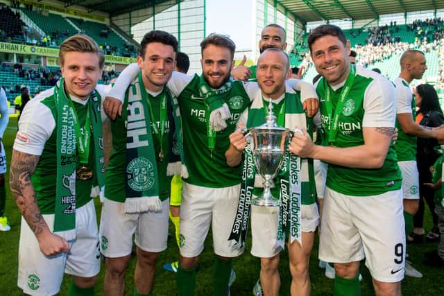 Holt celebrates winning the title with Jason Cummings, John McGinn, Andrew Shinnie, Liam Fontaine, and Dylan McGeouch