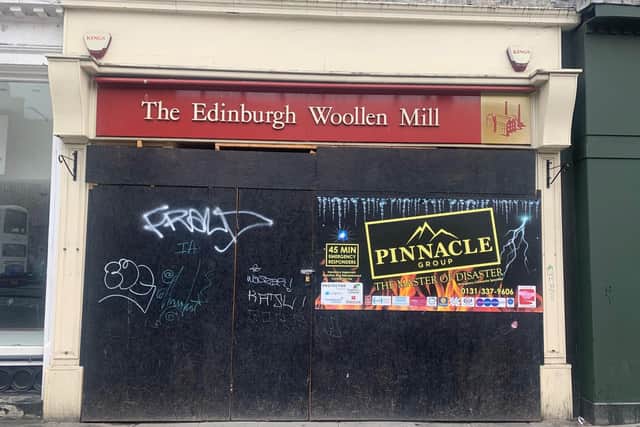 Graffiti on the boarded-up Edinburgh Woollen Mill in Princes Street
