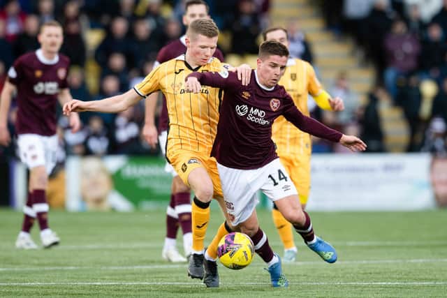 Livingston's Stephen Kelly and Hearts Cammy Devlin battle for possession in a scrappy first half. Picture: Ross Parker / SNS