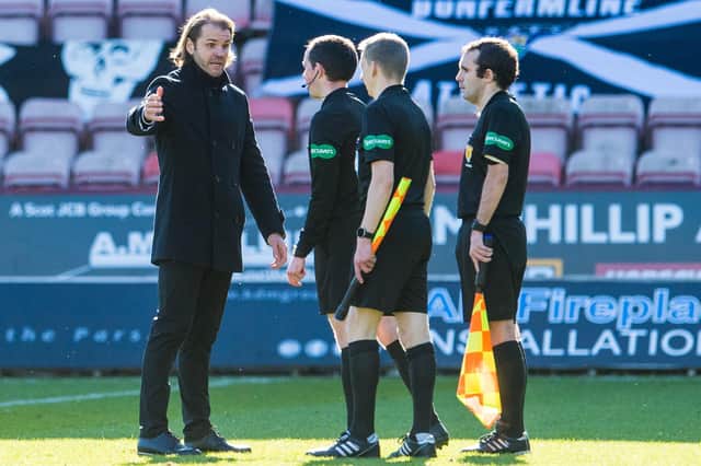 Hearts boss Robbie Neilson speaks to the officials at full-time.