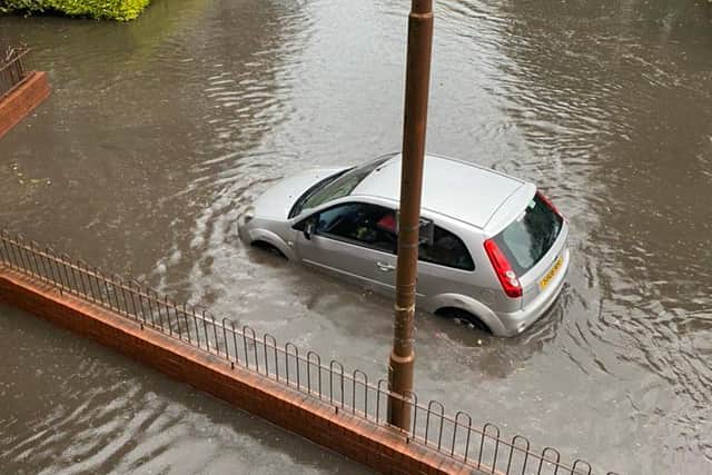 A car struggles in a submerged Gorgie street