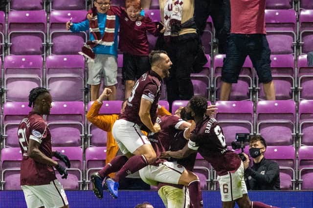 John Souttar celebrates making it 2-1 with teammates during a cinch Premiership match opener between Hearts and Celtic at Tynecastle on July 31
