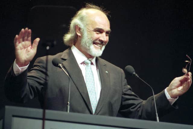 Sean Connery acknowledges his audience's cheers before receiving the Freedom of the City at the Usher Hall in Edinburgh in June 1991