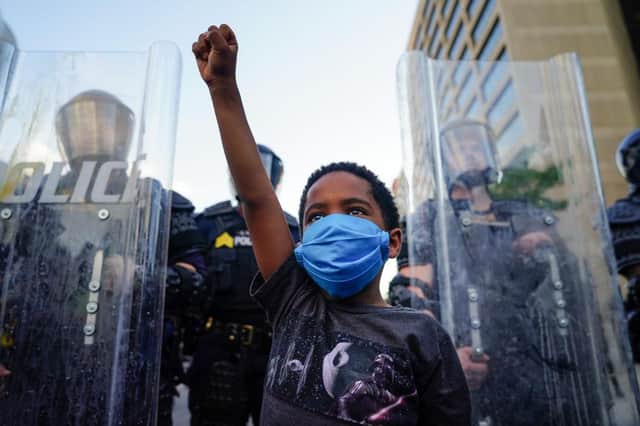 A young boy raises his fist for a photo during a demonstration in Atlanta, Georgia (Photo: Elijah Nouvelage/Getty Images)