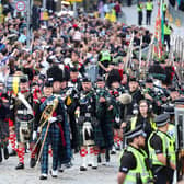 The Combined Cadet Force Pipes and Drums and the Cadet Military Band lead the People's Procession of 100 people representing many walks of life in Scotland down the Royal Mile.