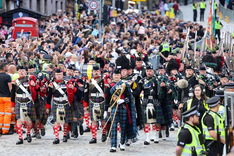 The Combined Cadet Force Pipes and Drums and the Cadet Military Band lead the People's Procession of 100 people representing many walks of life in Scotland down the Royal Mile.