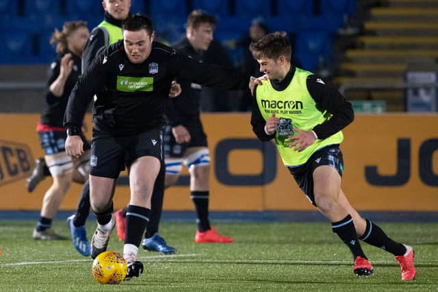 Glasgow's Zander Fagerson, left, and Ross Thompson play football on the Scotstoun pitch after the Guinness Pro14 match against Edinburgh was postponed. Picture: Alan Harvey/SNS