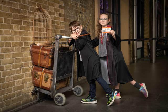 Molly (9) and Tom (7) pose with the Harry Potter Platform 9 ¾ trolley at King’s Cross Station, as it is announced that a replica trolley will soon be stopping at Edinburgh Waverley.