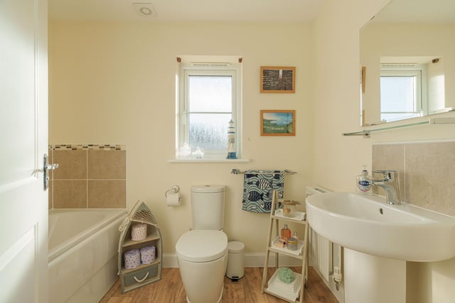 The family bathroom comprises of a three piece white suite.
