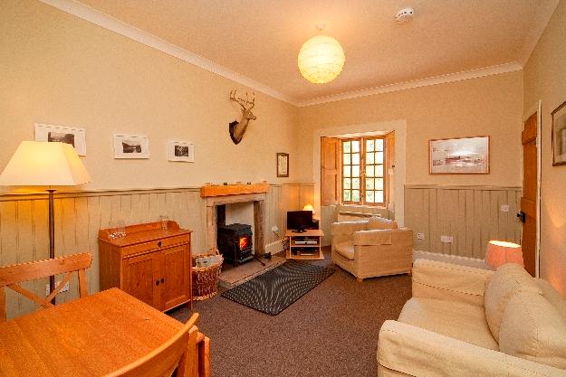 The Garden Cottage boasts a wood-panelled living room with wood burner.