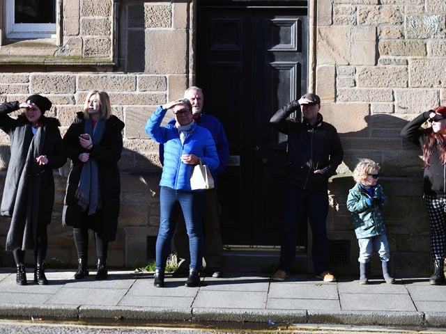Members of the public grab a decent vantage point to watch the proceedings as film crew and stars begin to arrive in town