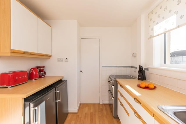 The fitted kitchen comes with three good sized storage cupboards, wall and base units and space for free standing white goods