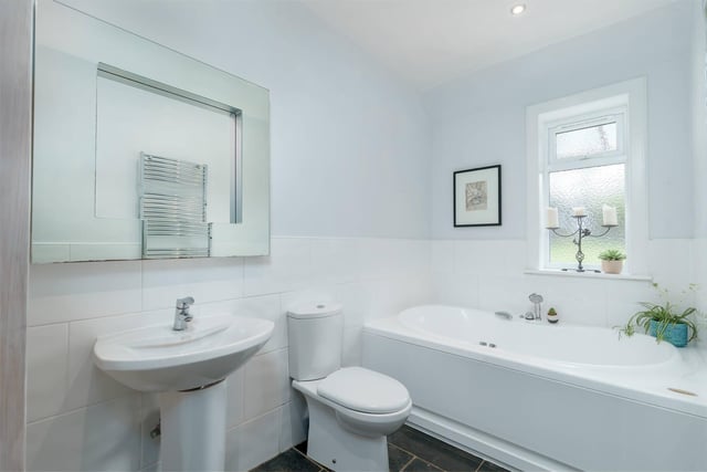 This family bathroom is presented in good condition, with a toilet, bath and shower.