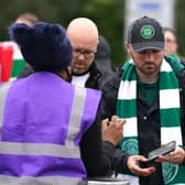 Celtic fans queue to show their vaccine passports as they enter the ground for the UEFA Europa League Group G match at Celtic Park, Glasgow.