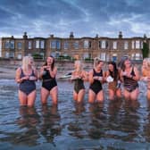 A group of wild swimmers hosted a coffee morning in Portobello's icy waves to raise cash for Macmillan Cancer Support. They braved the freezing water armed only with a swimming costume and a fresh cup of coffee at sunrise to promote the World's Biggest Coffee Morning.