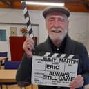 Jimmy Martin posing with the clapper board, which was used for his last appearance as 'Auld Eric' in Still Game.