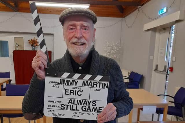 Jimmy Martin posing with the clapper board, which was used for his last appearance as 'Auld Eric' in Still Game.