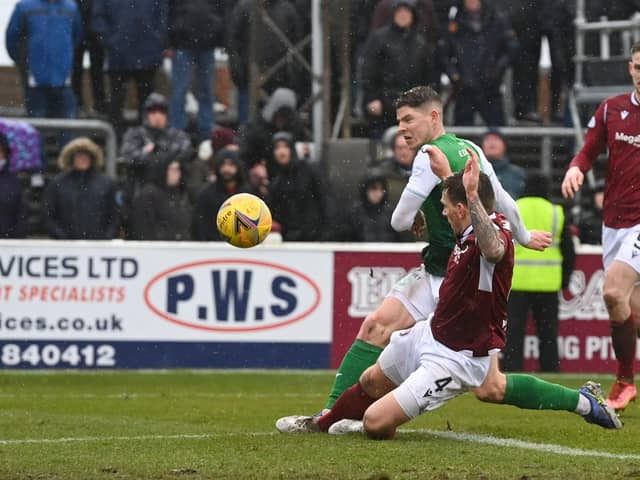 Kevin Nisbet gets in front of Ricky Little to fire Hibs into the lead at Gayfield