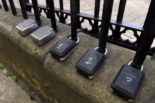 Stock photo of Air BnB key boxes on railings at Upper Bow, Edinburgh, by Lisa Ferguson.