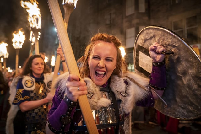One viking from the Shetland South Mainland Up Helly Aa Jarl Squad gets in the spirit as the group walks through the city centre.