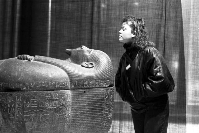 A female member of staff with the coffin of Psussenes, part of the Gold of the Pharaohs exhibition of ancient Egyptian artifacts at the City Art Gallery in January 1988.